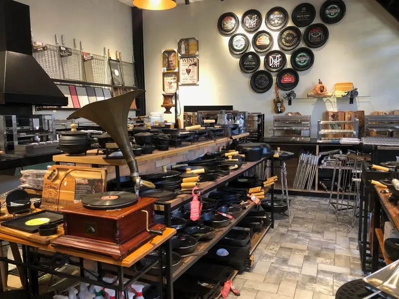 Showroom com mesa de panelas de ferro e acessórios