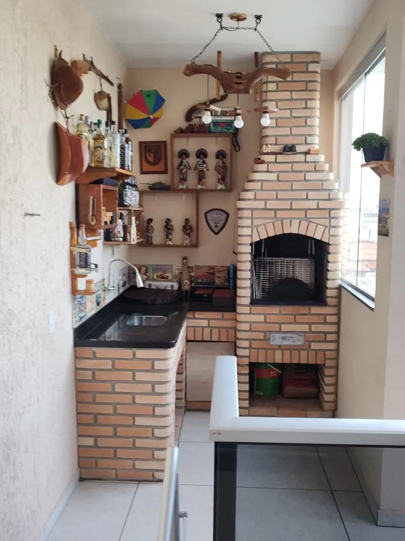 Cantinho gourmet com forno e churrasqueira de tijolinho aparente